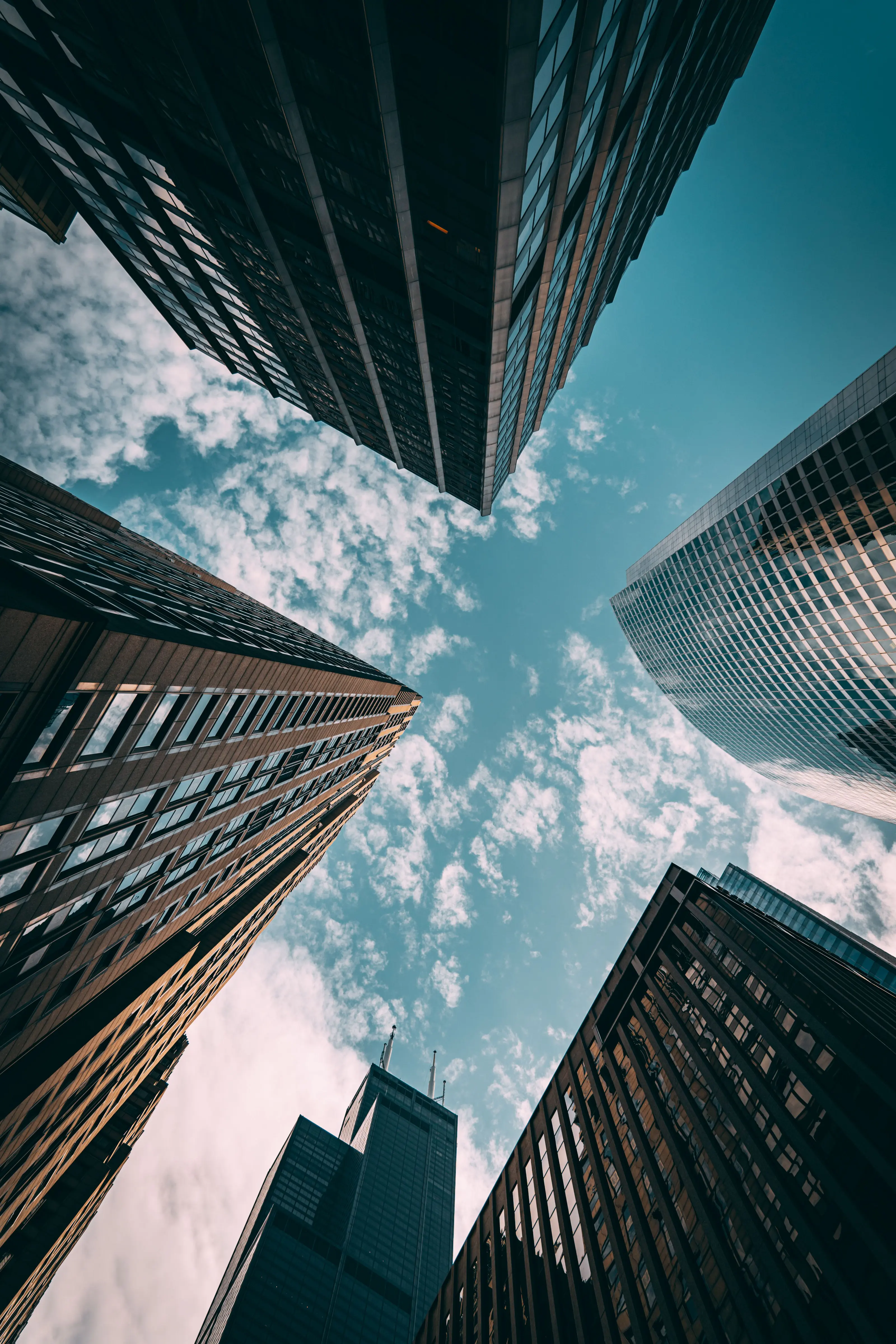 A high-rise residential tower seen from below against an open sky